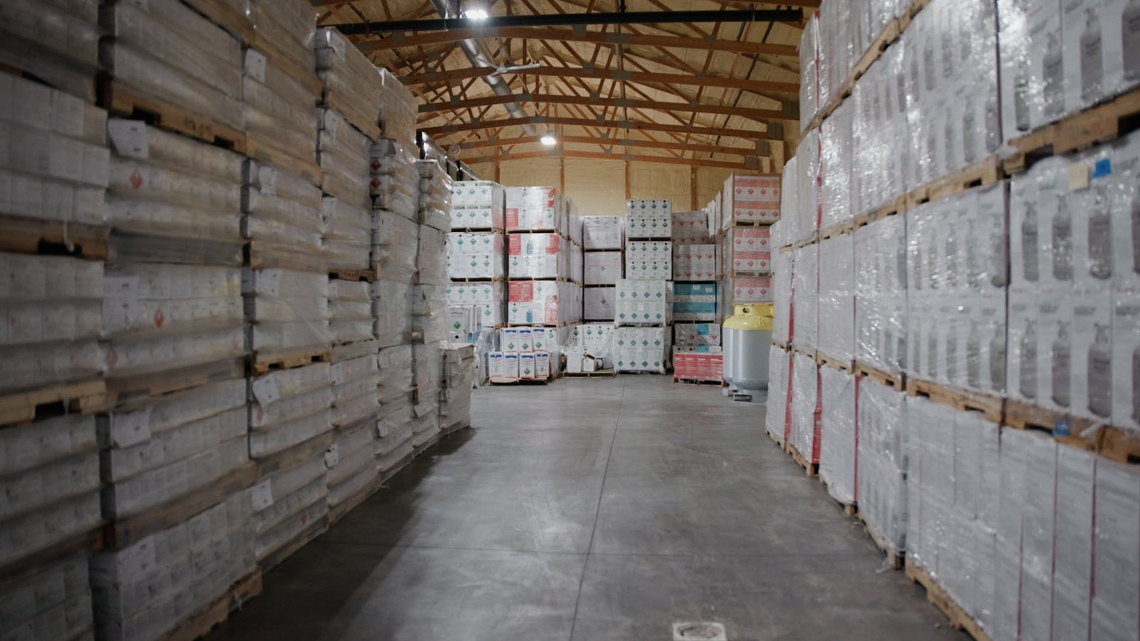 Warehouse aisle stacked with product during Lenz Distributing operations video production